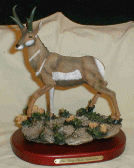 Figurine featuring a pronghorn Antelope walking in a rocky area
